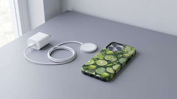Lime Art iPhone tough case at the end of a charging chain laid out with a wall adapter, cable and magnetic puck