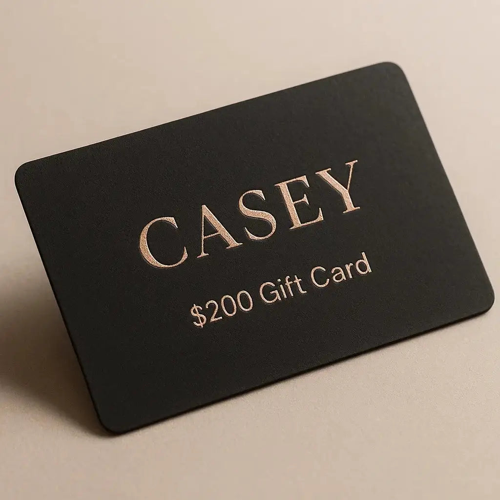 Black gift card with 'CASEY' and '$200 Gift Card' text on a beige background