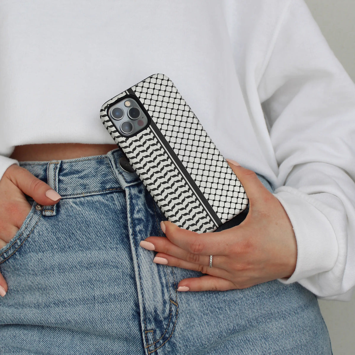 The Kuffiya iPhone case — woven keffiyeh motif on a dual-layer MagSafe shell
